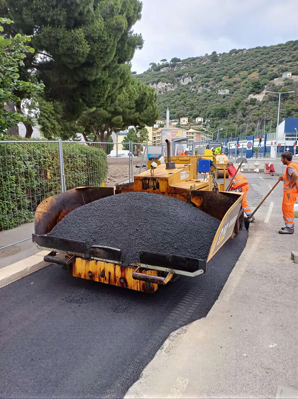 Le finisseur SC2R charge d'enrobe chaud, equipe au poste, en bord de littoral
